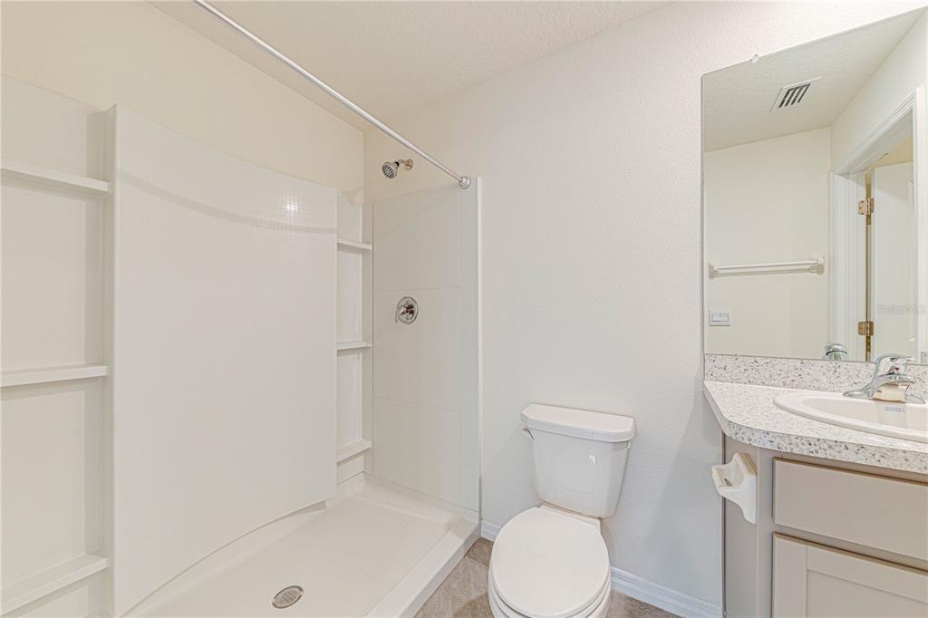 34026 Soaring Bamboo Path Wesley Chapel, FL 33543 - Photo 17 of 34 a bathroom with a sink a toilet and shower