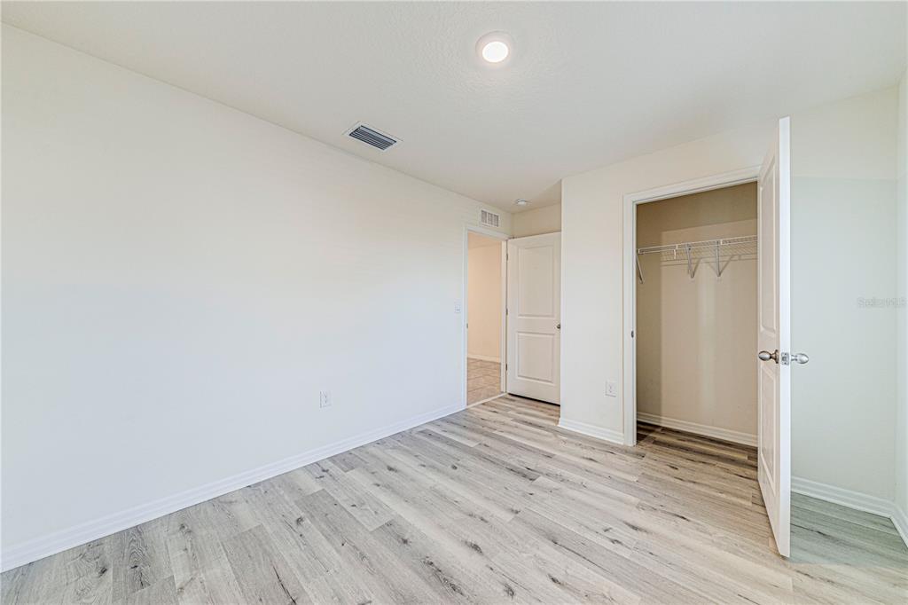 34026 Soaring Bamboo Path Wesley Chapel, FL 33543 - Photo 18 of 34 wooden floor in an empty room