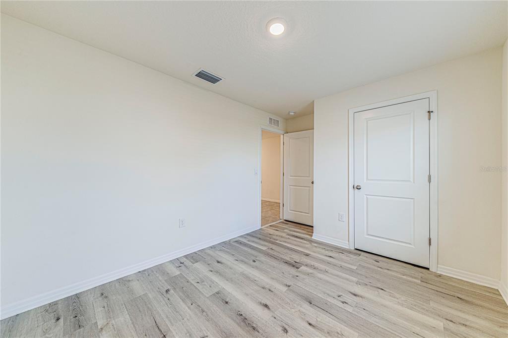 34026 Soaring Bamboo Path Wesley Chapel, FL 33543 - Photo 19 of 34 a view of room with wooden floor