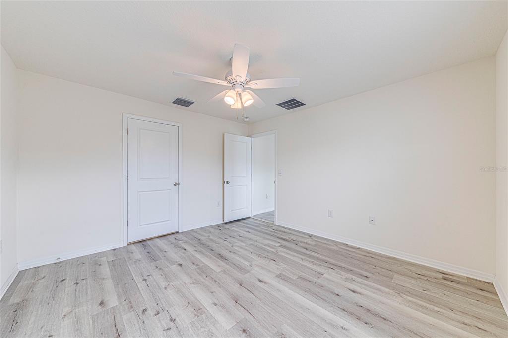 34026 Soaring Bamboo Path Wesley Chapel, FL 33543 - Photo 20 of 34 wooden floor in an empty room