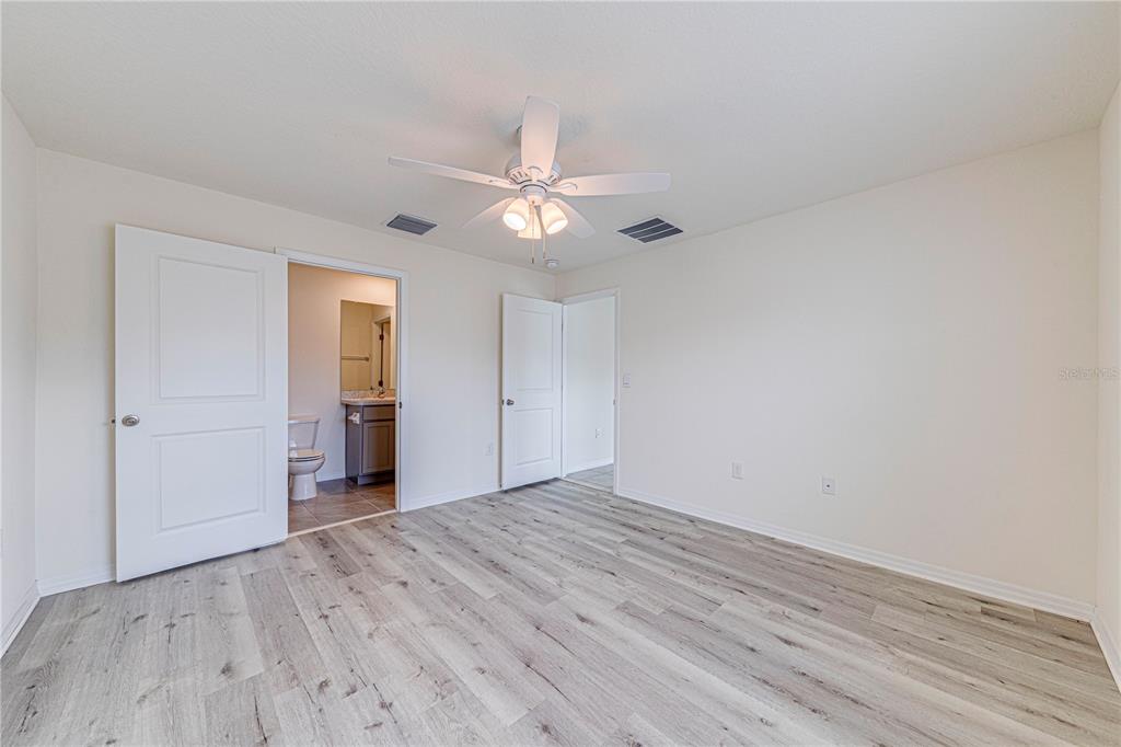 34026 Soaring Bamboo Path Wesley Chapel, FL 33543 - Photo 23 of 34 wooden floor in an empty room