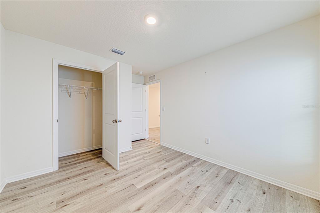 34026 Soaring Bamboo Path Wesley Chapel, FL 33543 - Photo 27 of 34 wooden floor in an empty room