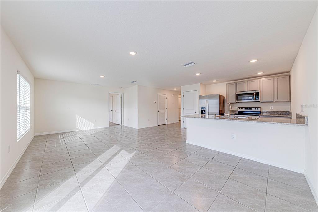 34026 Soaring Bamboo Path Wesley Chapel, FL 33543 - Photo 6 of 34 a large kitchen with stainless steel appliances lots of counter top space and cabinets