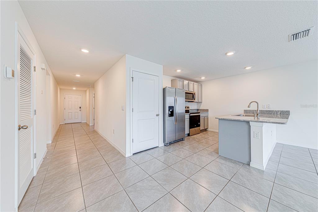 34026 Soaring Bamboo Path Wesley Chapel, FL 33543 - Photo 7 of 34 a view of a kitchen with electric appliances