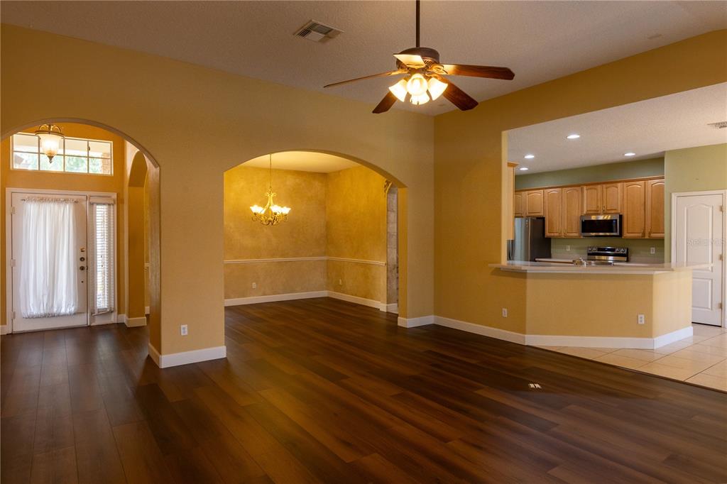 65 Calliope Street Ocoee, FL 34761 - Photo 9 of 60 a view of a room with wooden floor and window
