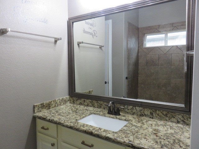 2607 Alan Lake Lane Spring, TX 77388 - Photo 14 of 42 a bathroom with a granite countertop sink and a mirror