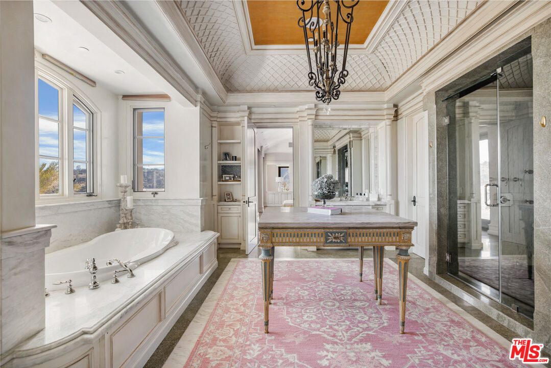 1940 Bel Air Road Los Angeles, CA 90077 - Photo 12 of 25 a spacious bathroom with a double vanity sink mirror and bathtub