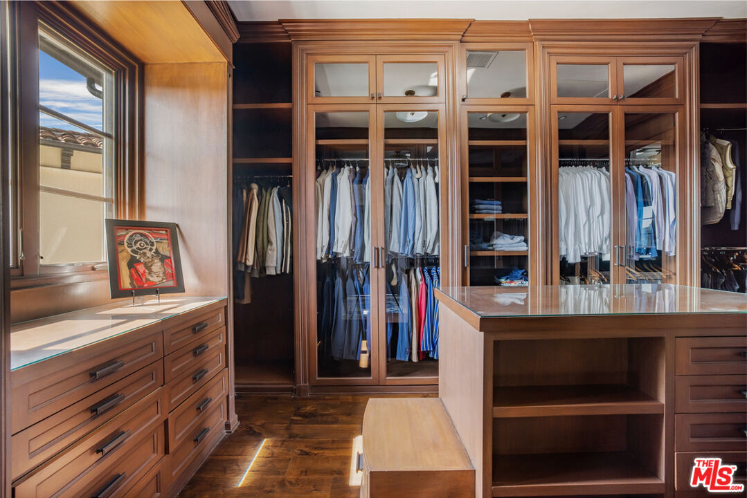 1940 Bel Air Road Los Angeles, CA 90077 - Photo 14 of 25 a view of walk in closet with clothes and shoes