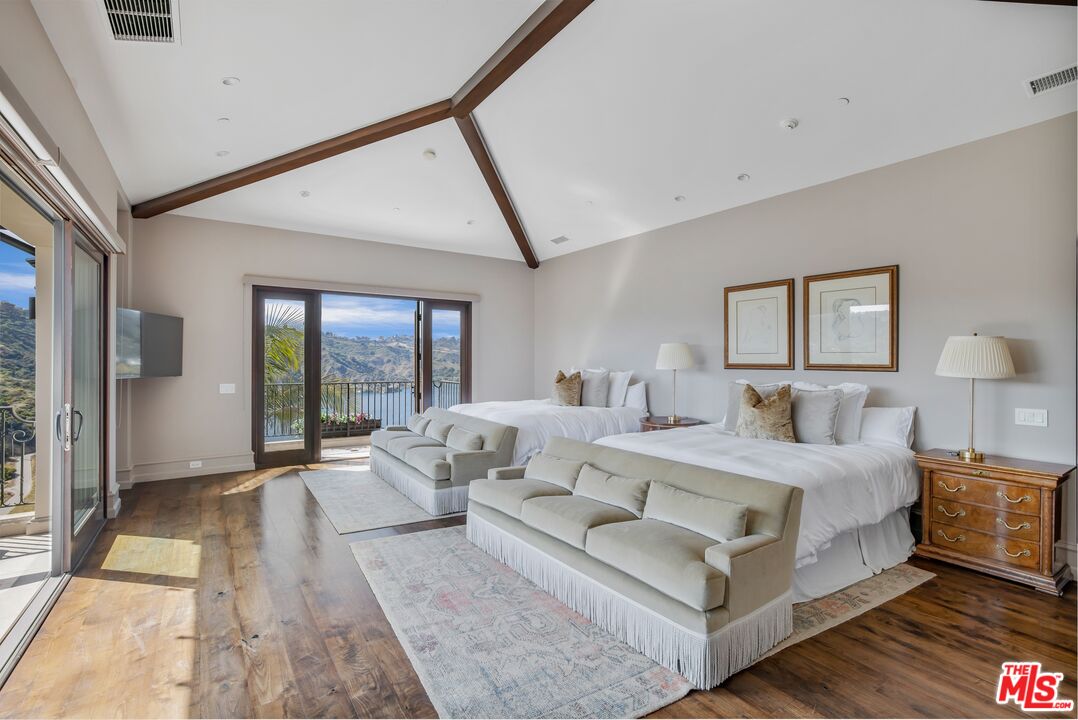 1940 Bel Air Road Los Angeles, CA 90077 - Photo 15 of 25 a bedroom with a bed couch and large window