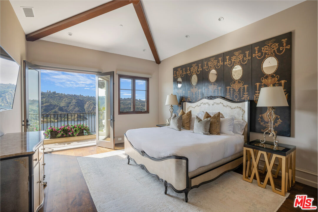 1940 Bel Air Road Los Angeles, CA 90077 - Photo 16 of 25 a bedroom with a large bed and a large window