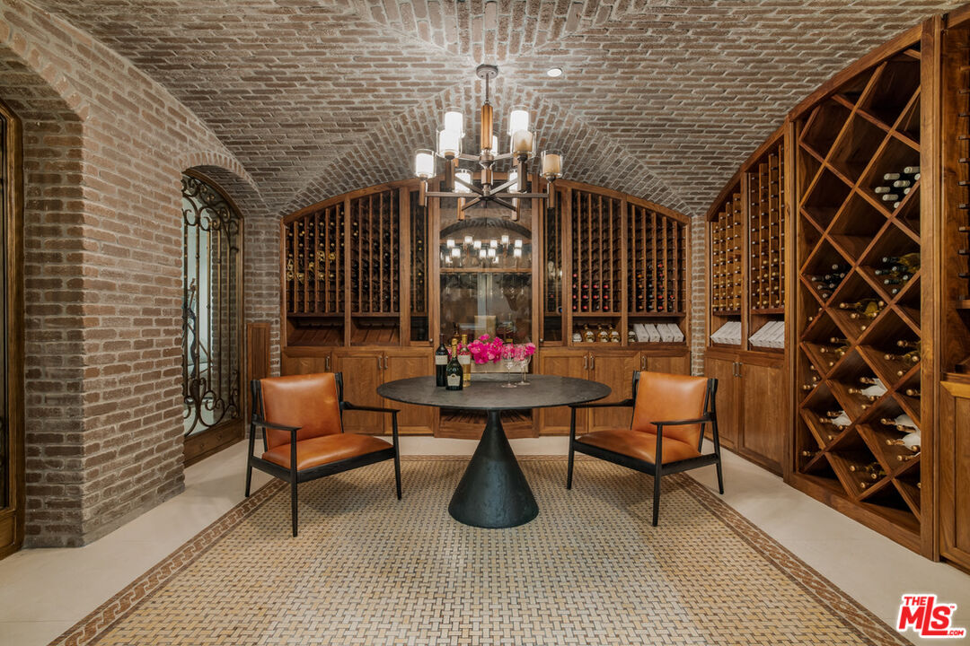 1940 Bel Air Road Los Angeles, CA 90077 - Photo 22 of 25 a living room with patio furniture and a chandelier