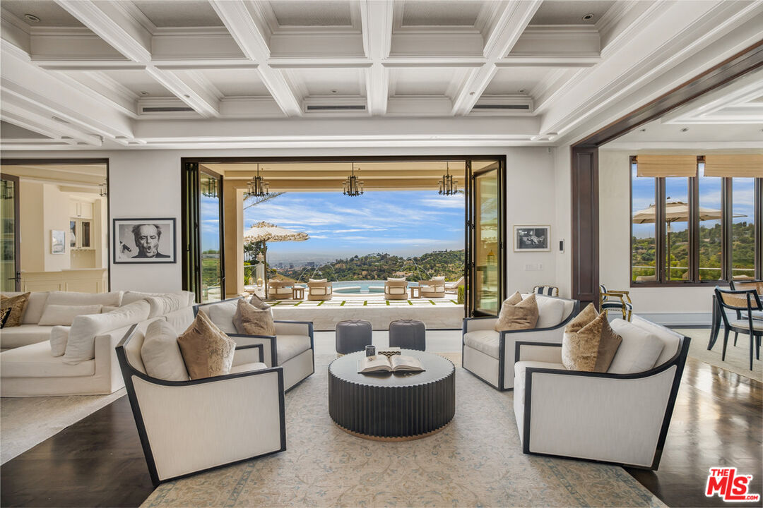 1940 Bel Air Road Los Angeles, CA 90077 - Photo 3 of 25 a living room with furniture and a potted plant
