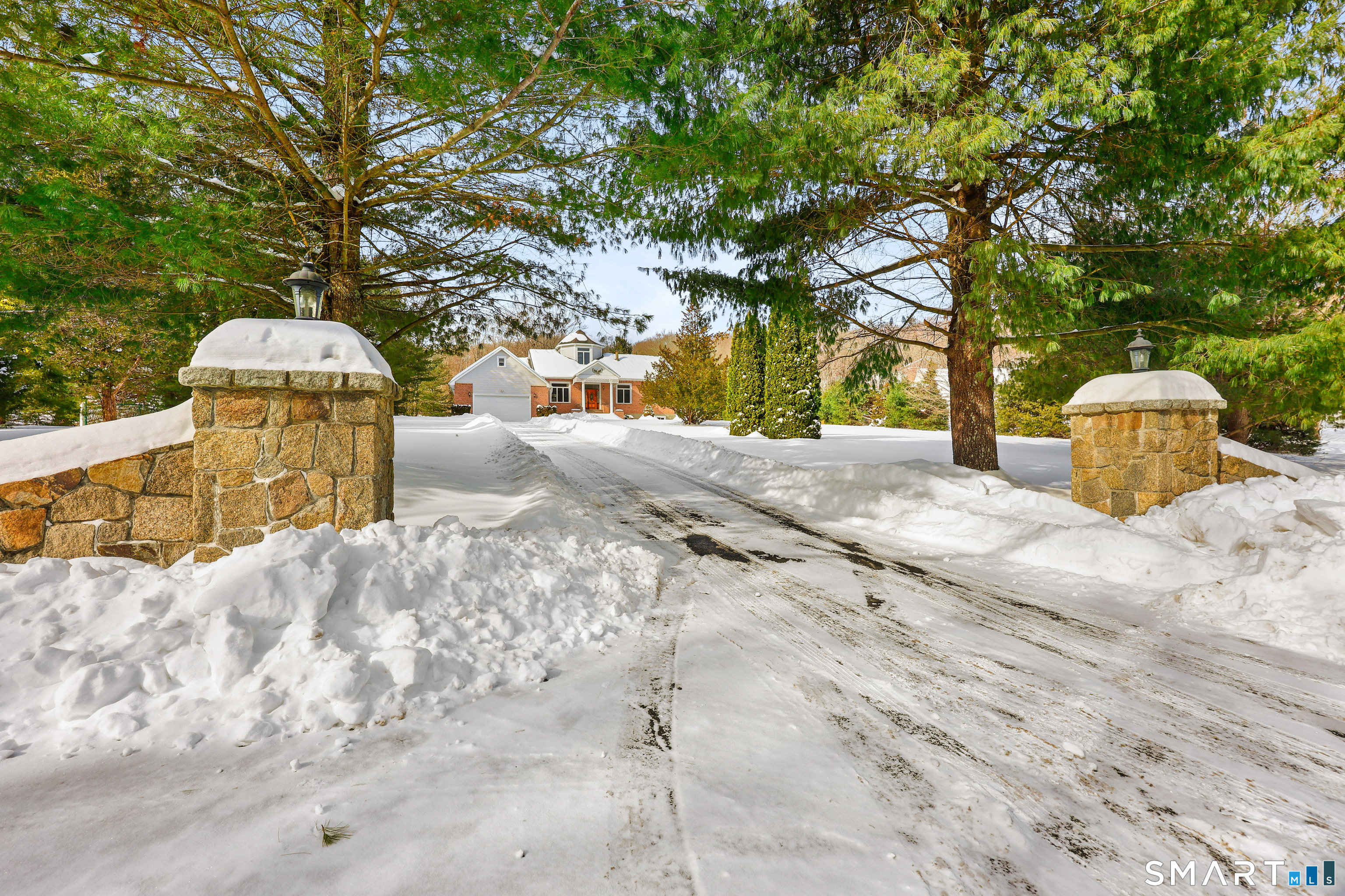 striking stone pillar driveway entrance!