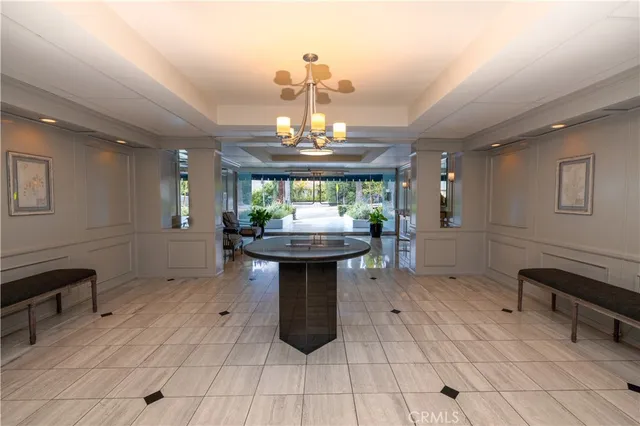 a lobby with furniture and a chandelier