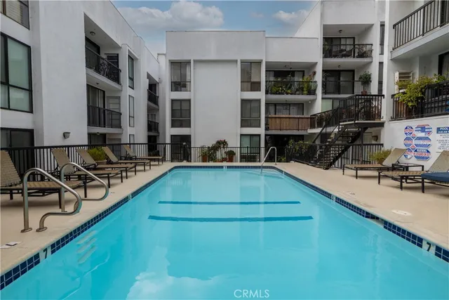 a view of a house with swimming pool and sitting area