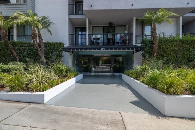 front view of a house with a yard and potted plants