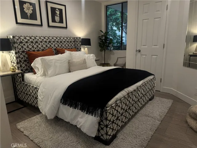 a bedroom with a bed and a potted plant