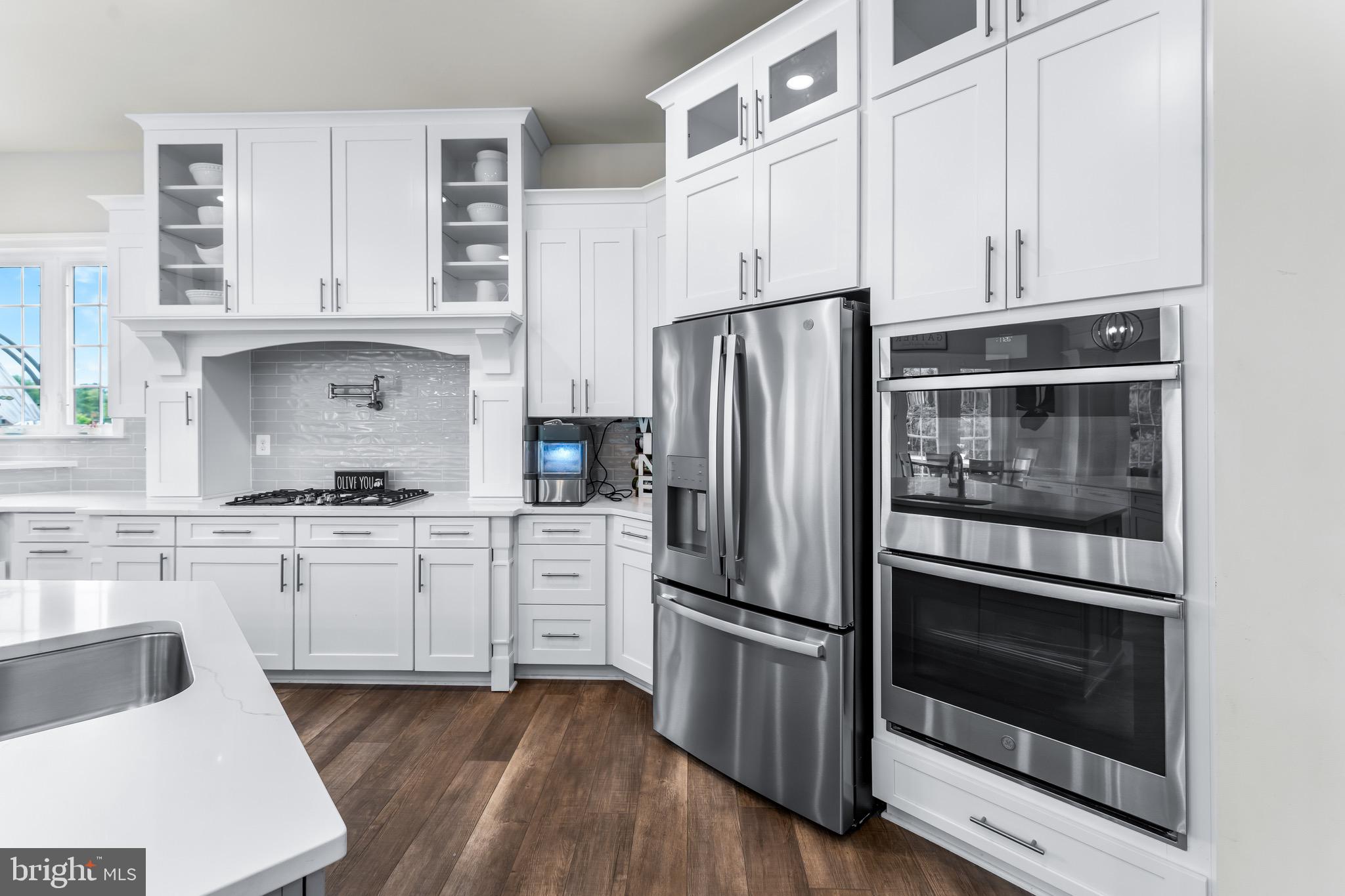12201 Mayapple Trail Sykesville, MD 21784 - Photo 15 of 75 a kitchen with white cabinets and stainless steel appliances