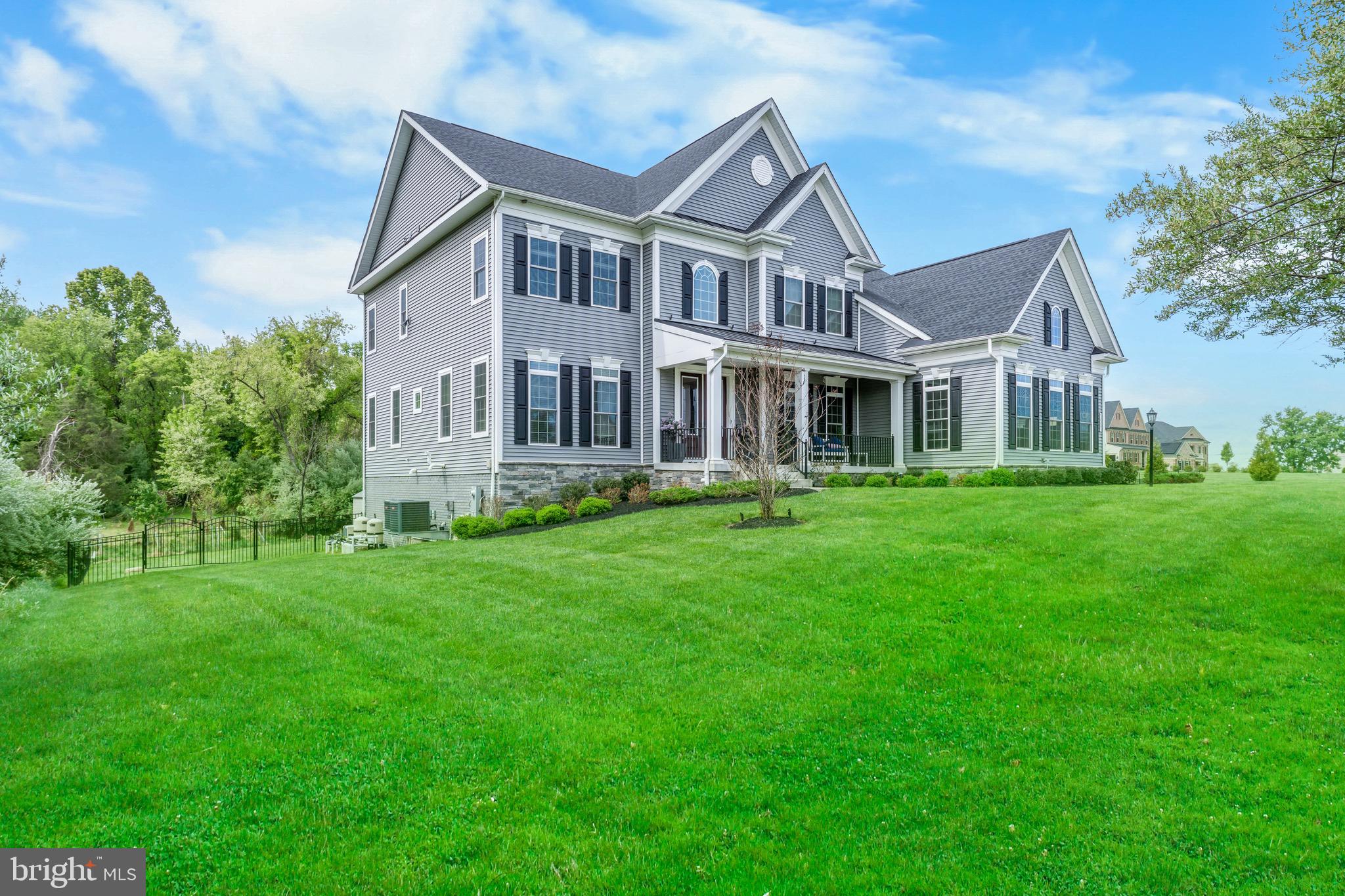 12201 Mayapple Trail Sykesville, MD 21784 - Photo 2 of 75 a front view of a house with a garden and trees