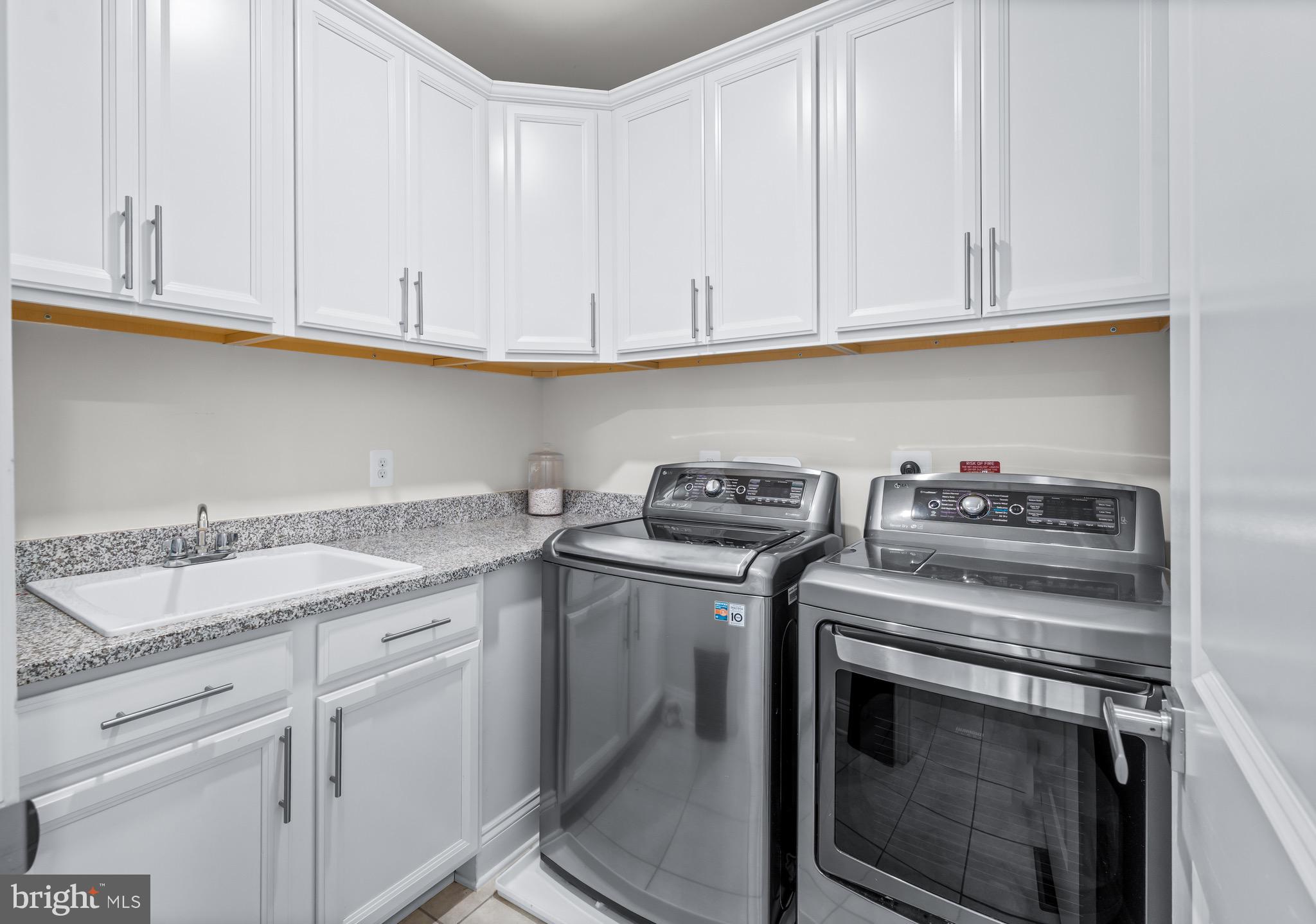 12201 Mayapple Trail Sykesville, MD 21784 - Photo 32 of 75 a kitchen with granite countertop white cabinets and a stove