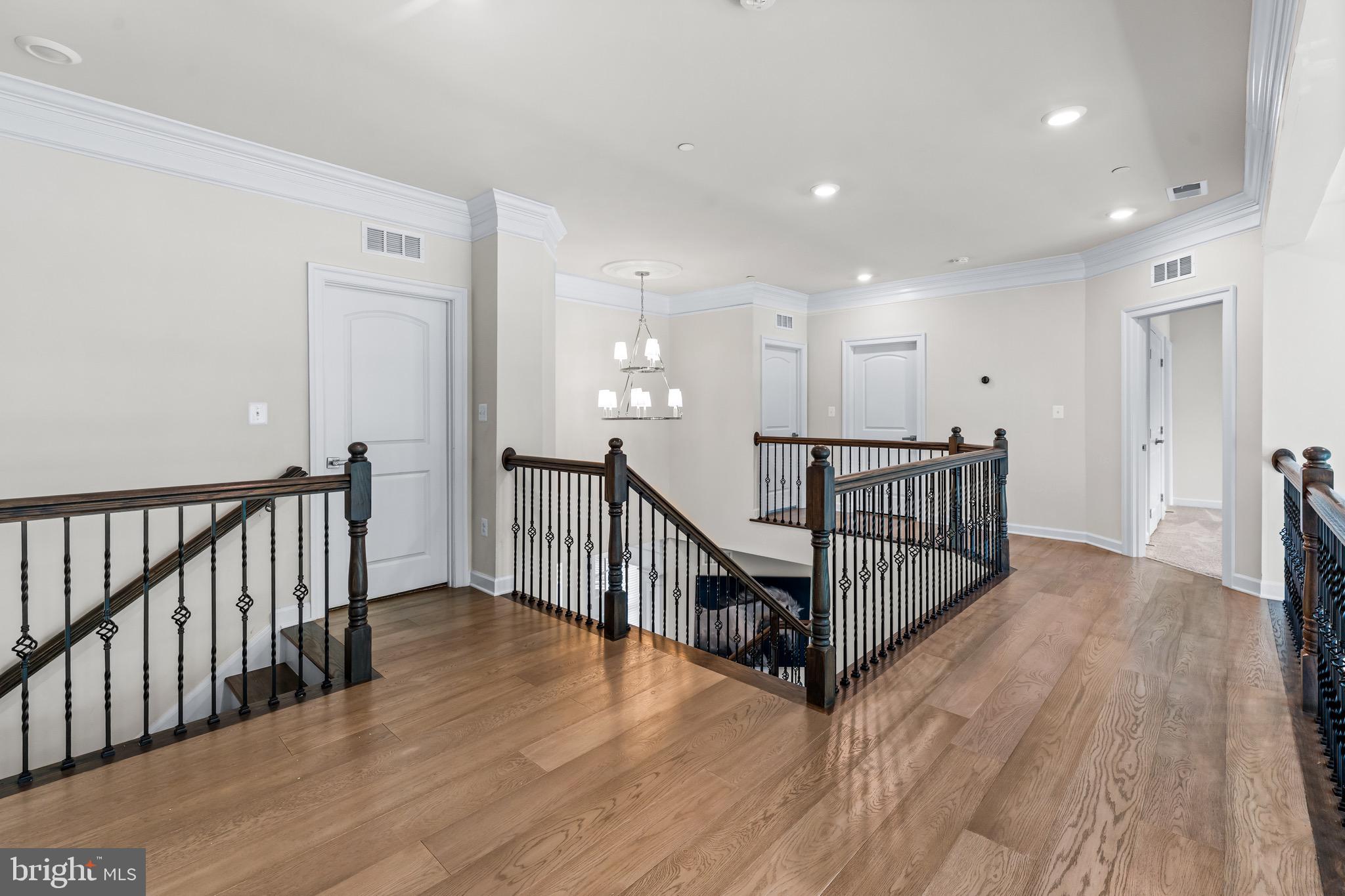 12201 Mayapple Trail Sykesville, MD 21784 - Photo 33 of 75 a view of a hallway with wooden floor and stairs
