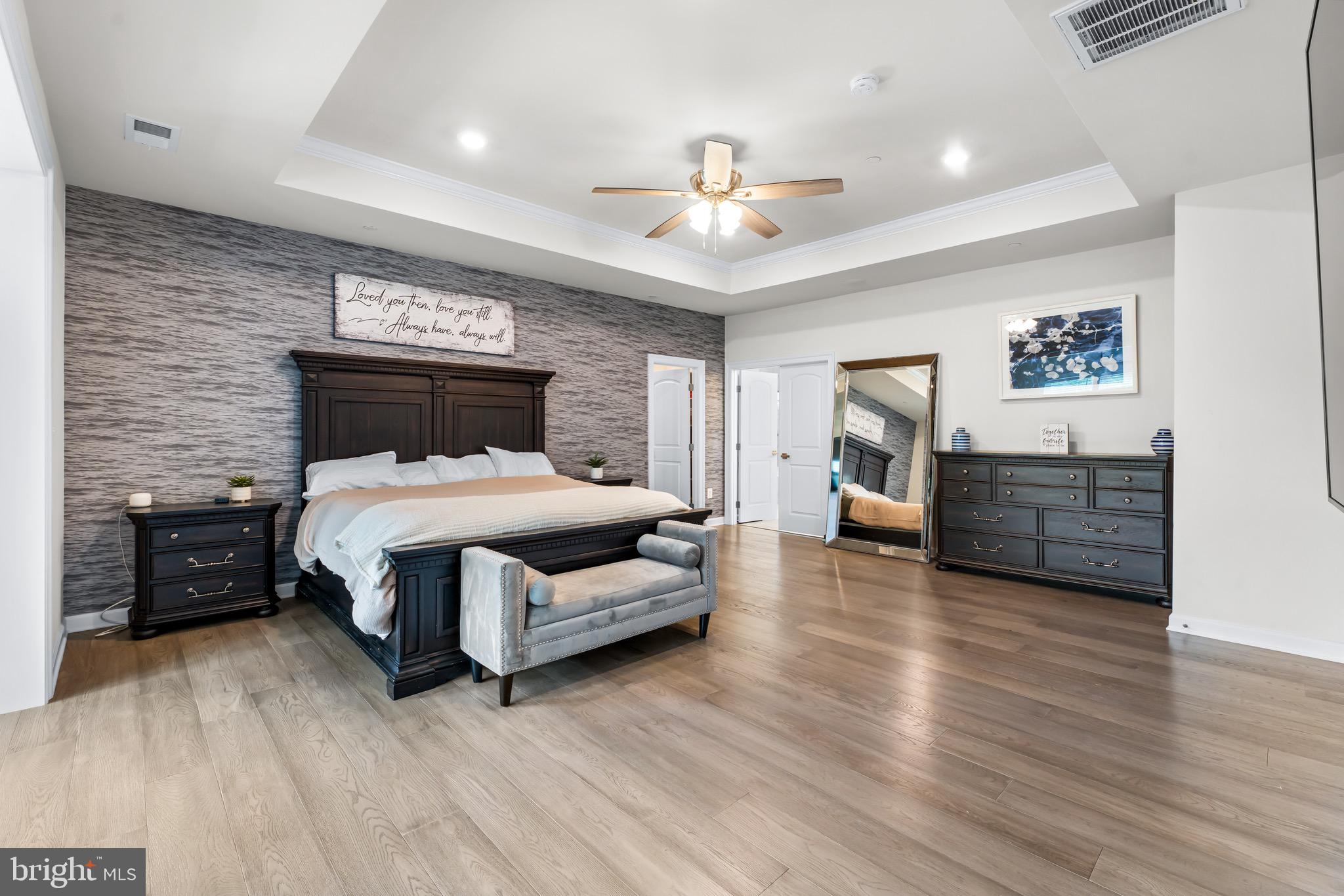 12201 Mayapple Trail Sykesville, MD 21784 - Photo 35 of 75 a bedroom with a large bed and a chandelier