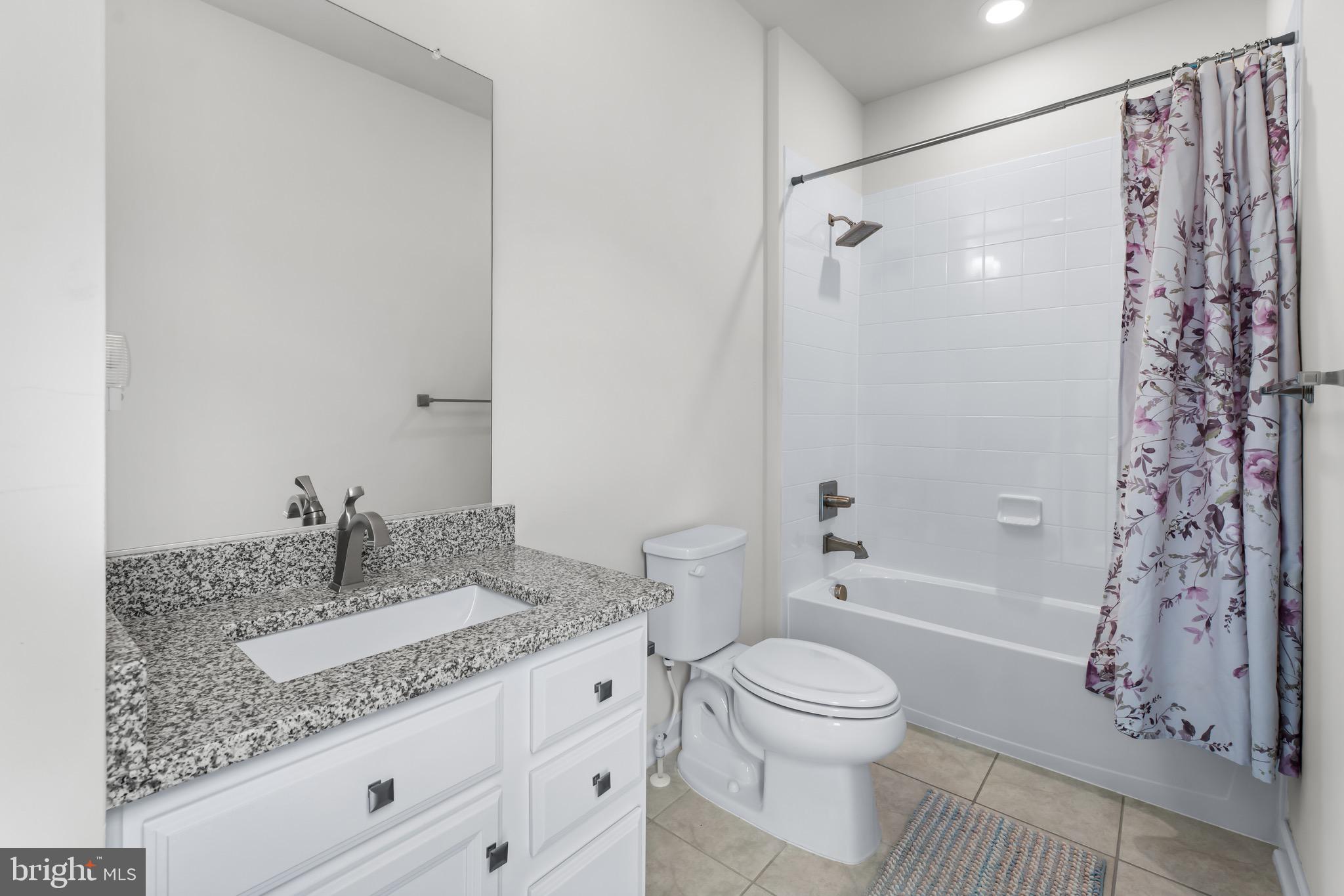12201 Mayapple Trail Sykesville, MD 21784 - Photo 49 of 75 a bathroom with a granite countertop sink toilet a shower and a mirror