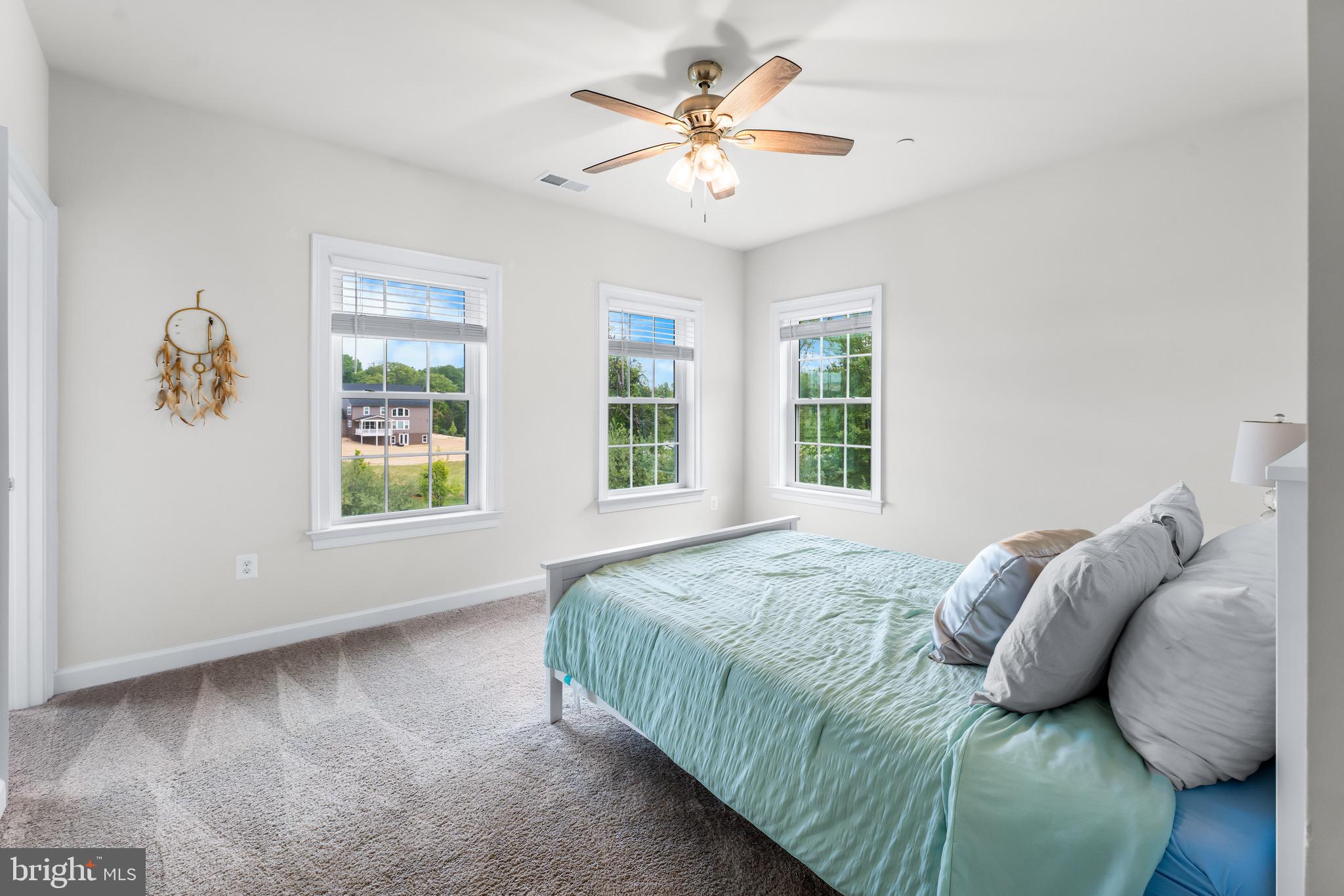 12201 Mayapple Trail Sykesville, MD 21784 - Photo 52 of 75 a bedroom with a bed and a large window