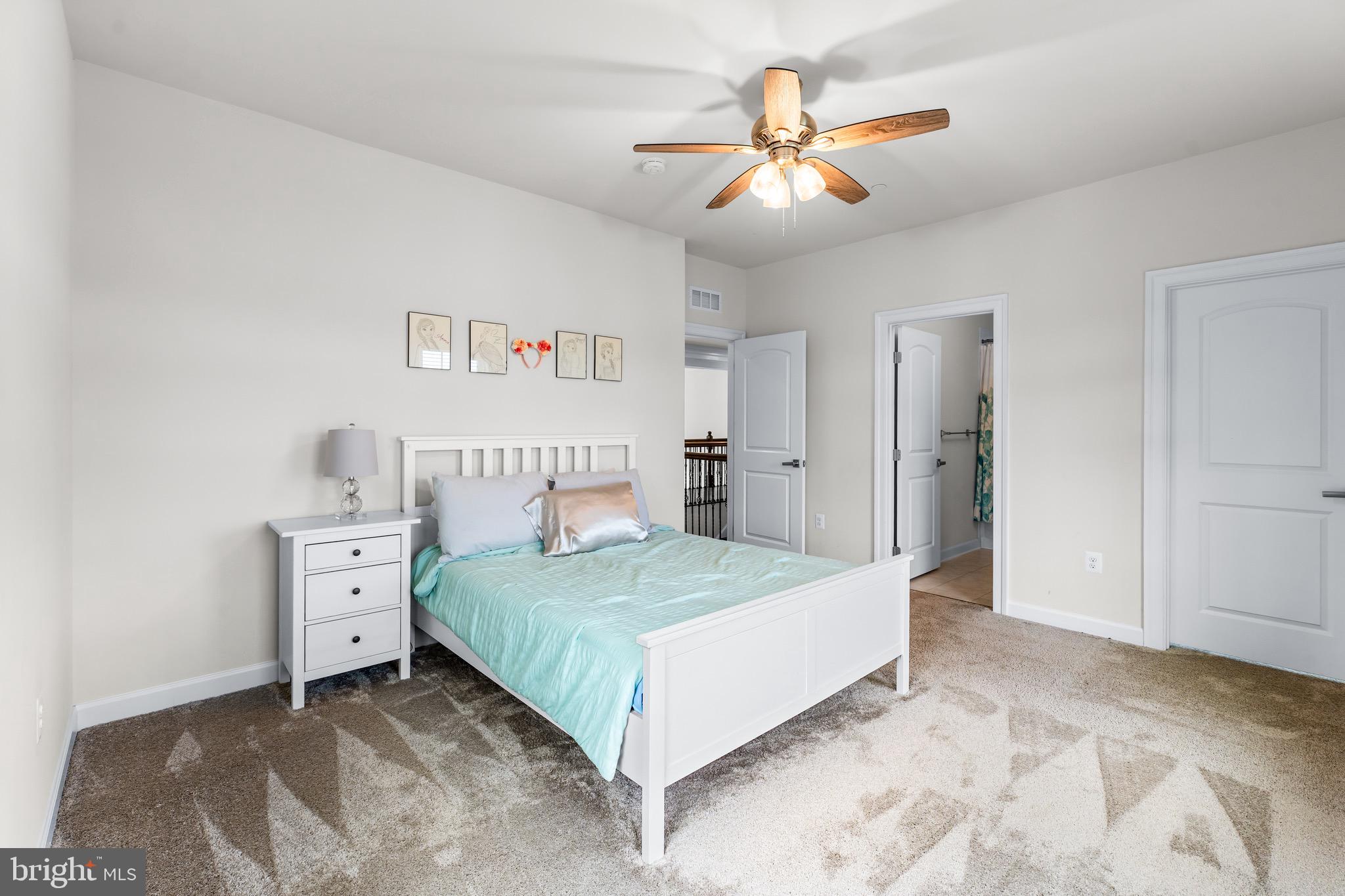 12201 Mayapple Trail Sykesville, MD 21784 - Photo 53 of 75 a bedroom with a large bed and a chandelier