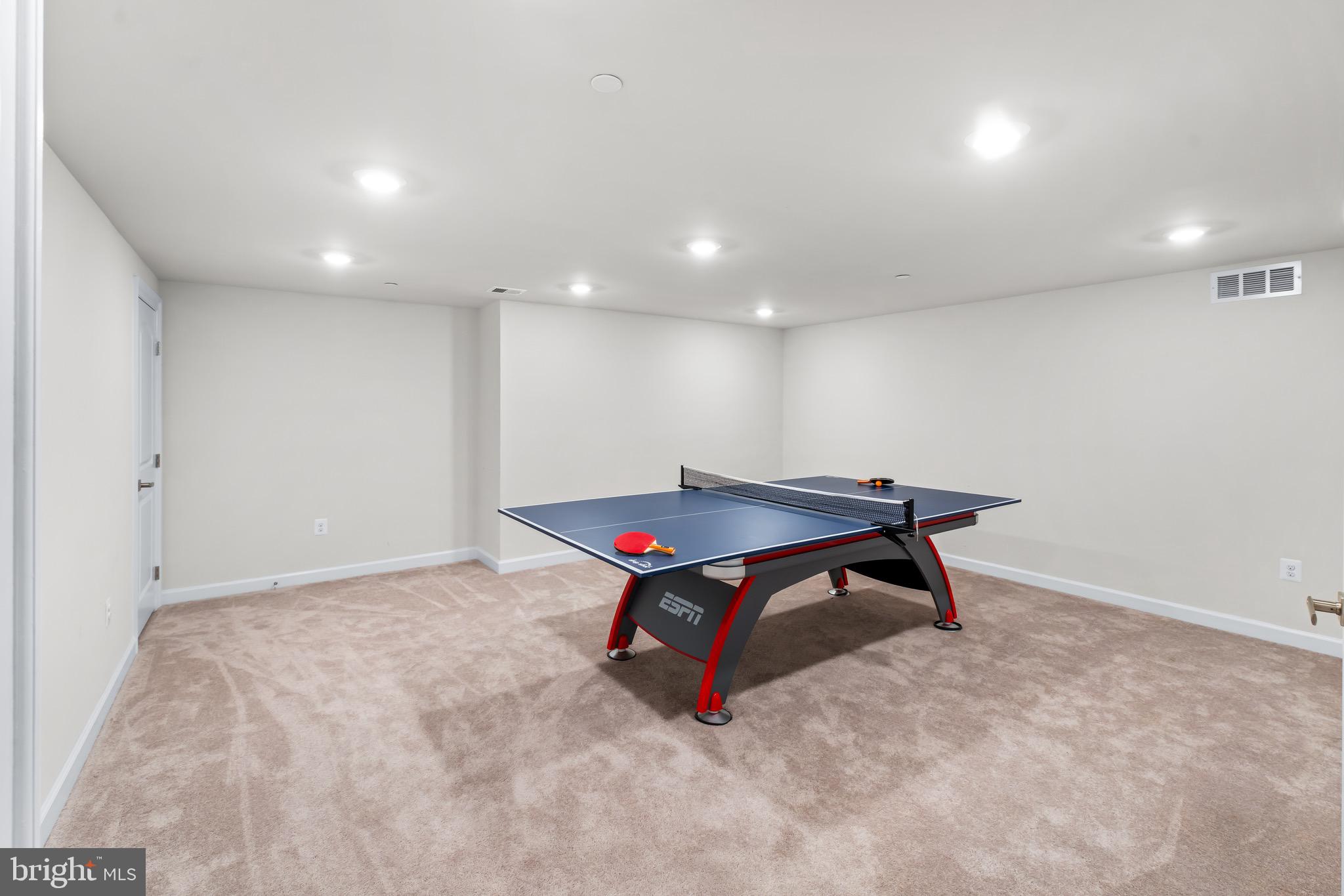 12201 Mayapple Trail Sykesville, MD 21784 - Photo 59 of 75 a living room with a table and a wooden floor