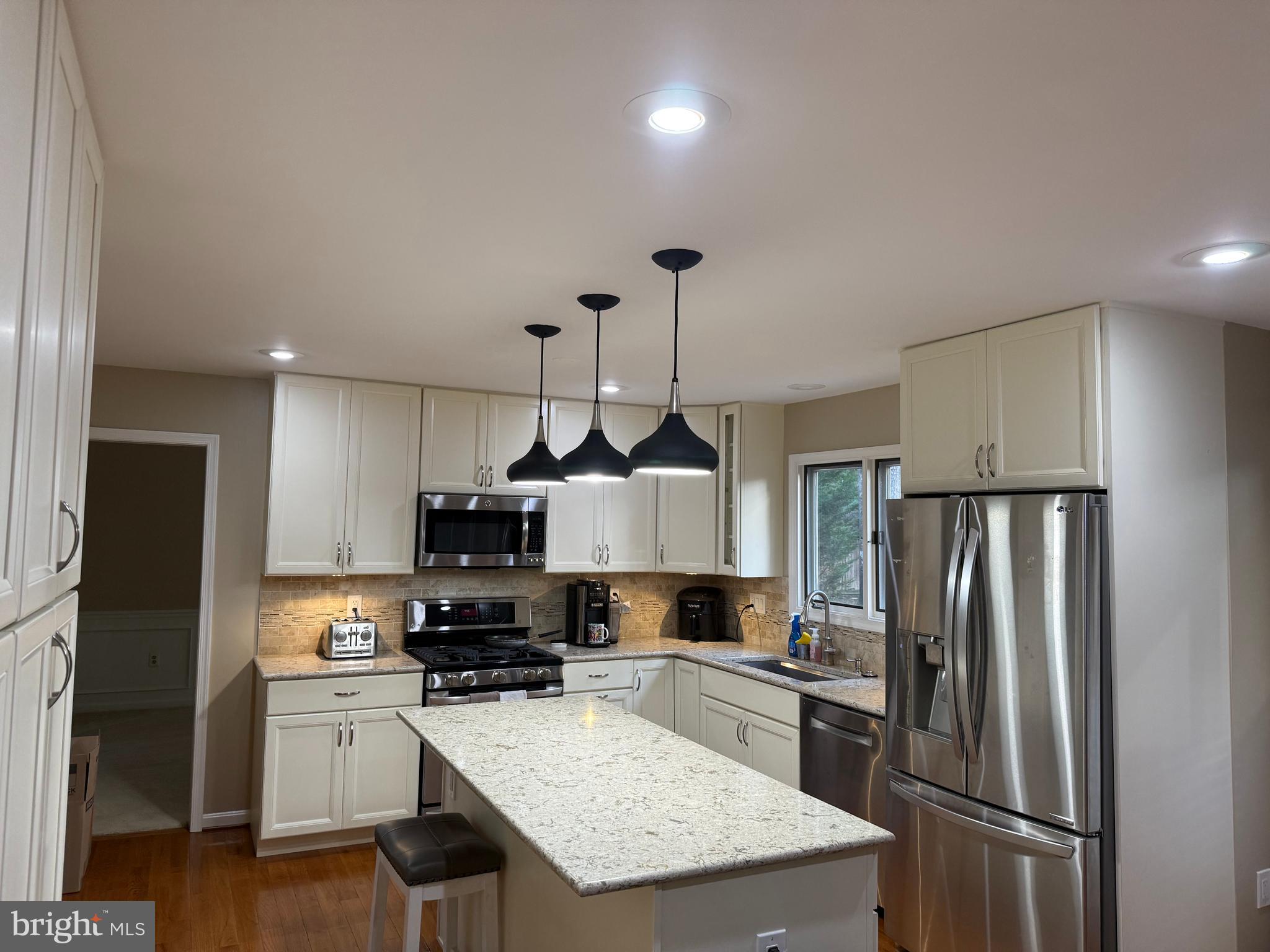 3869 Appaloosa Drive Woodbridge, VA 22192 - Photo 9 of 16 a kitchen with a refrigerator a microwave oven a sink and dishwasher