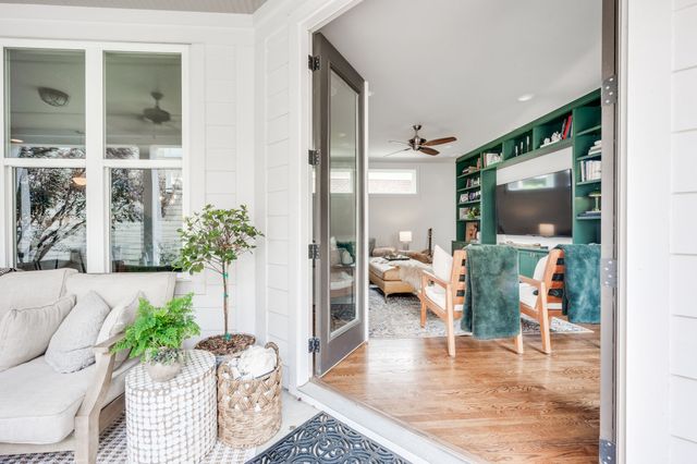 a kitchen with stainless steel appliances kitchen island granite countertop a dining table chairs and white cabinets