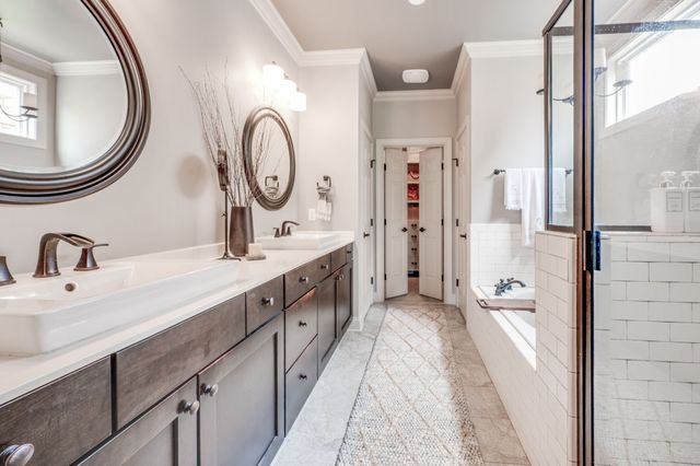 a bathroom with a double vanity sink and a mirror