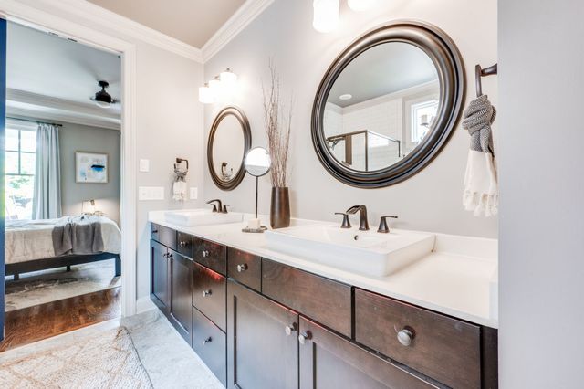 a spacious bathroom with a double vanity sink a mirror and a shower