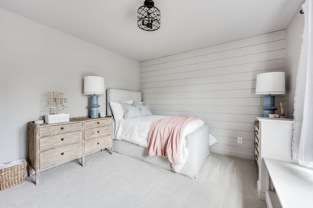 a living room with patio furniture and a potted plant