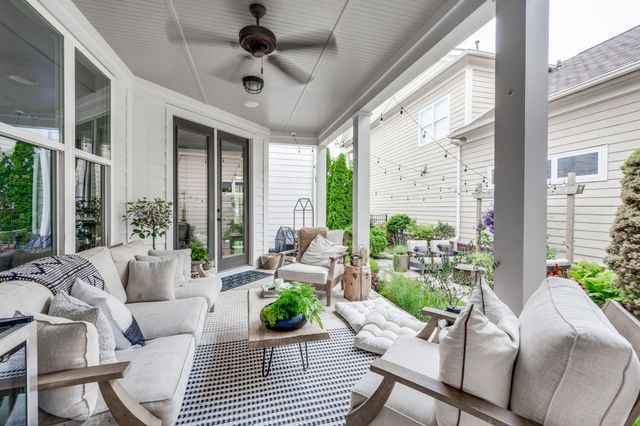 a view of a patio with couches and potted plants