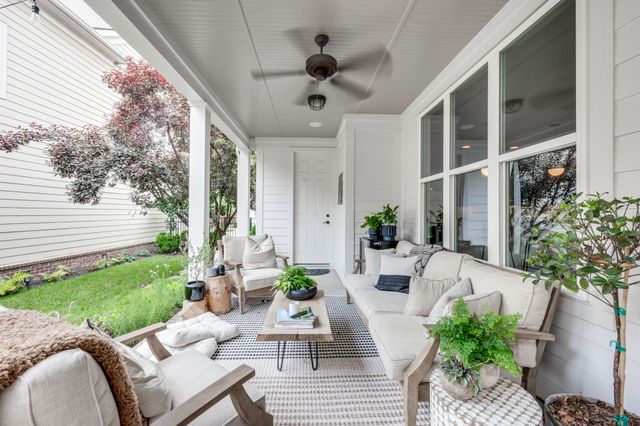 a front view of a house with garden and outdoor seating