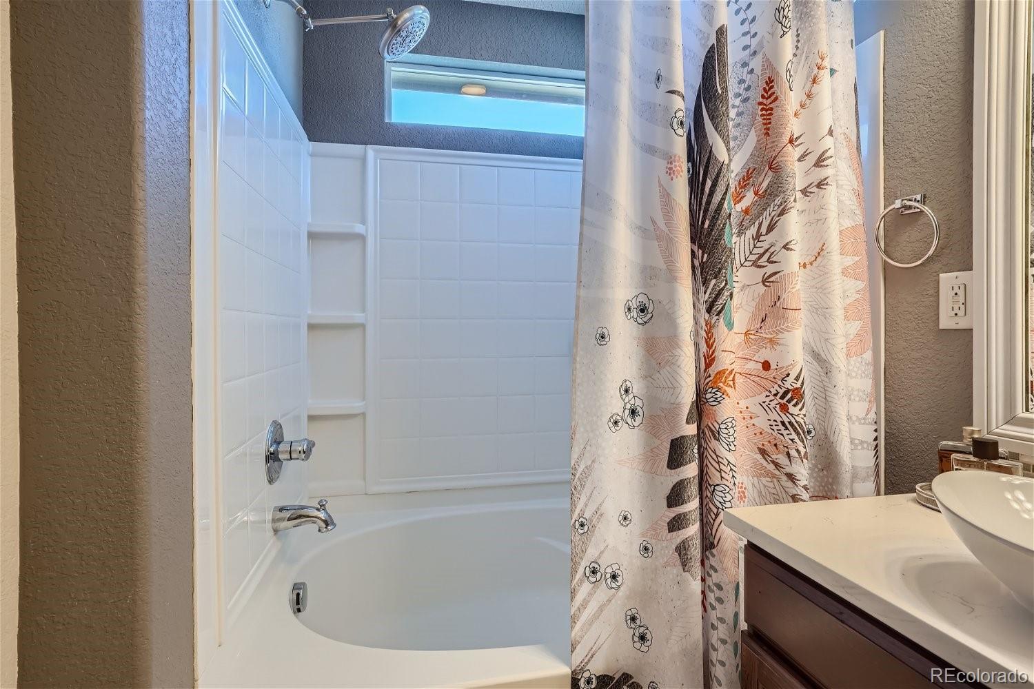 3085 Meadowbrook Place Dacono, CO 80514 - Photo 13 of 32 a bathroom with a bathtub and shower
