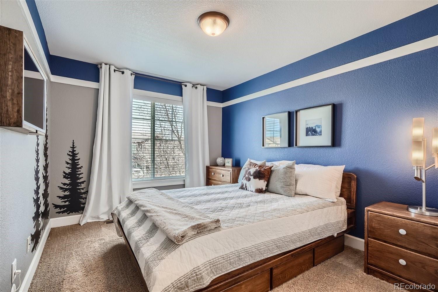 3085 Meadowbrook Place Dacono, CO 80514 - Photo 15 of 32 a bedroom with a bed and a window