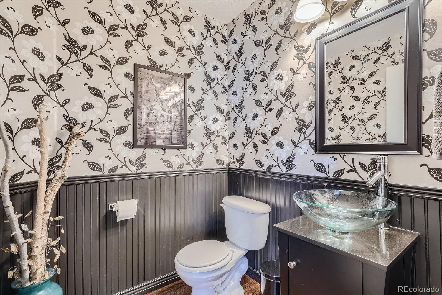 3085 Meadowbrook Place Dacono, CO 80514 - Photo 20 of 32 a bathroom with a granite countertop sink and a toilet