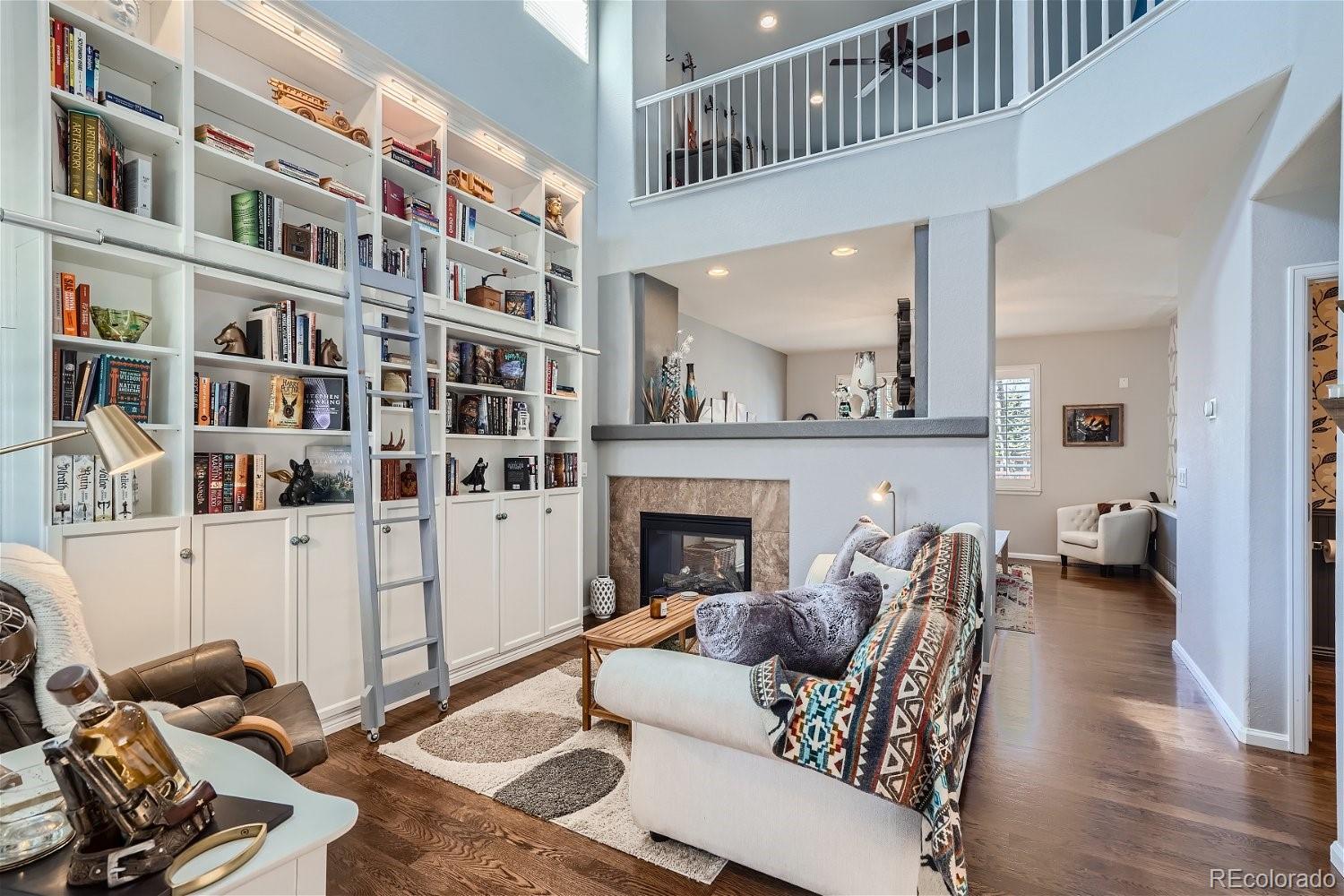 3085 Meadowbrook Place Dacono, CO 80514 - Photo 2 of 32 a living room with furniture and a fireplace