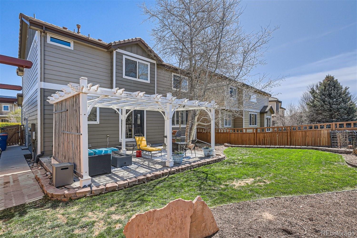 3085 Meadowbrook Place Dacono, CO 80514 - Photo 24 of 32 a front view of house with yard and patio