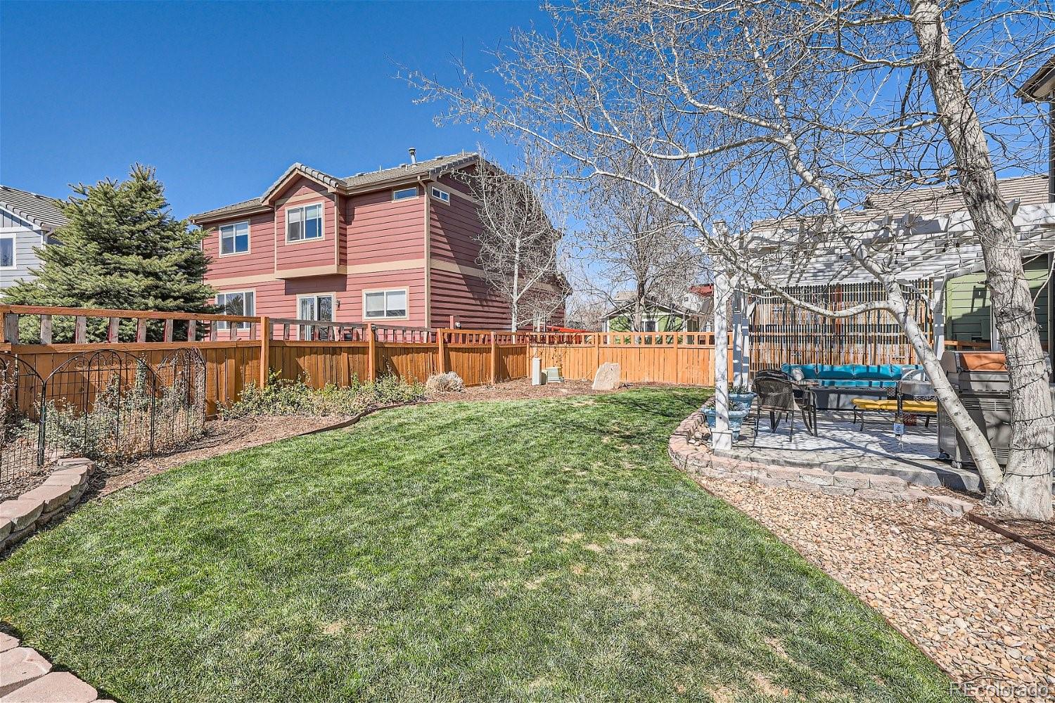 3085 Meadowbrook Place Dacono, CO 80514 - Photo 26 of 32 a view of a house with a yard