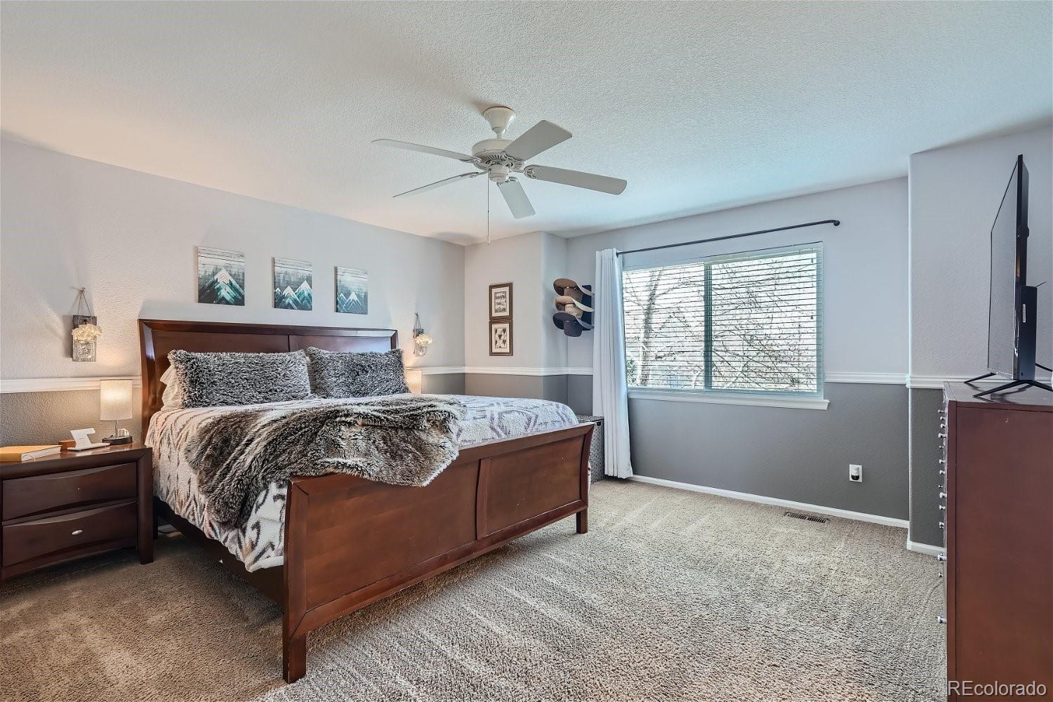 3085 Meadowbrook Place Dacono, CO 80514 - Photo 10 of 32 a bed sitting in a bedroom next to a window