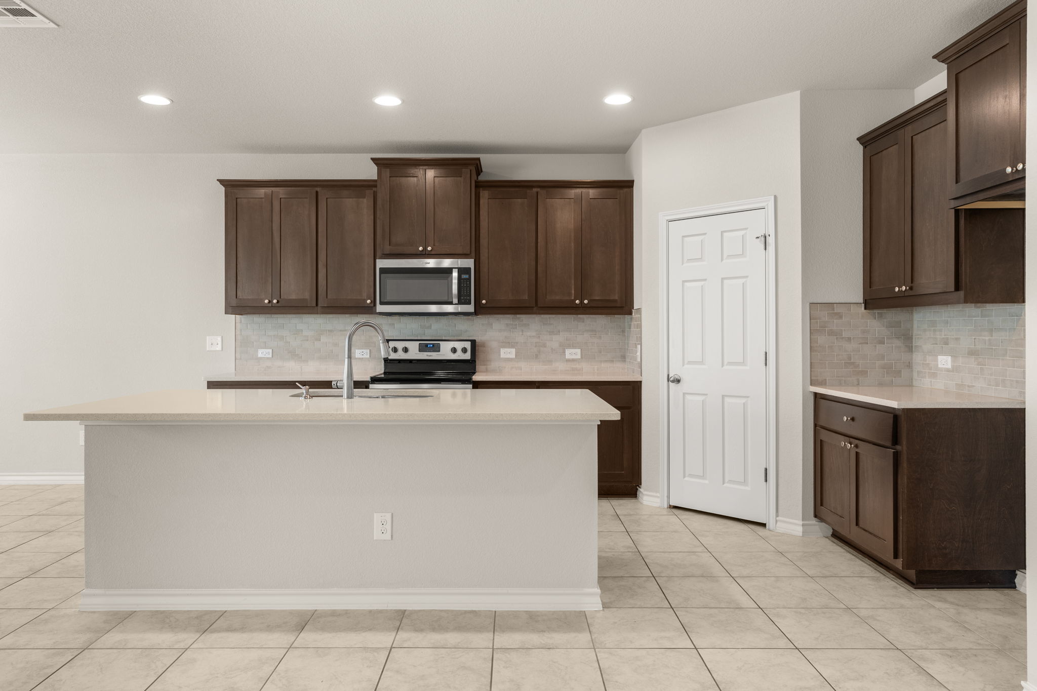 740 Aliso Trail Leander, TX 78641 - Photo 10 of 35 The kitchen features a center island that adds prep space and casual seating.