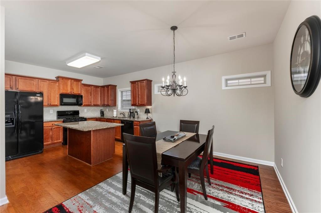 113 Tyson Woods Road Acworth, GA 30102 - Photo 12 of 37 a kitchen with stainless steel appliances granite countertop a refrigerator a sink dishwasher a stove with wooden floor