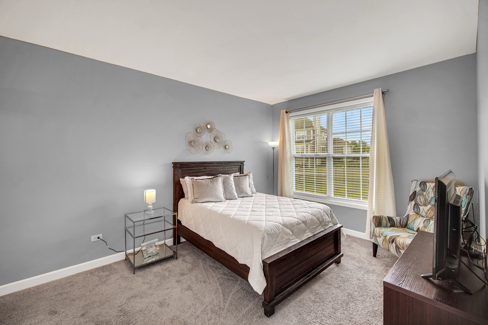 16512 Mueller Circle Plainfield, IL 60586 - Photo 24 of 29 a bed sitting in a bedroom next to a window