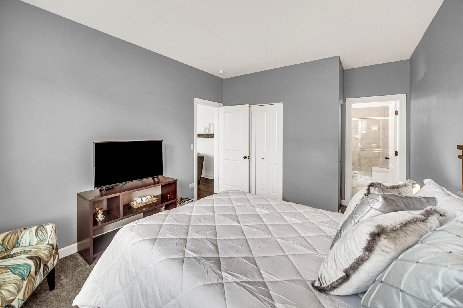 16512 Mueller Circle Plainfield, IL 60586 - Photo 25 of 29 a bedroom with a bed and a flat screen tv