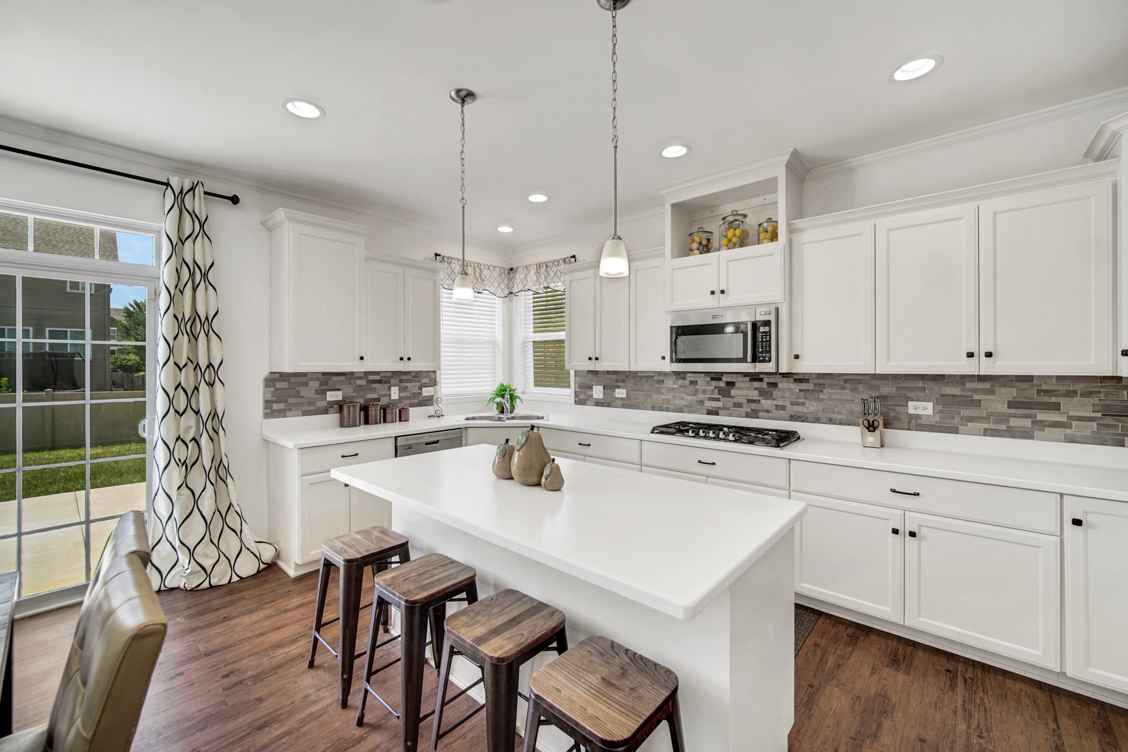 16512 Mueller Circle Plainfield, IL 60586 - Photo 8 of 29 a kitchen with white cabinets and white appliances