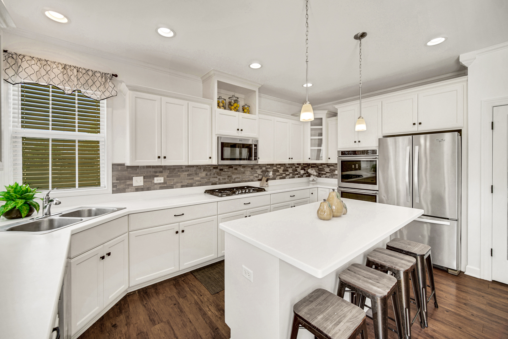 16512 Mueller Circle Plainfield, IL 60586 - Photo 9 of 29 a kitchen with white cabinets and white appliances
